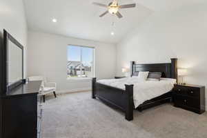 Carpeted bedroom featuring baseboards, recessed lighting, ceiling fan, and vaulted ceiling