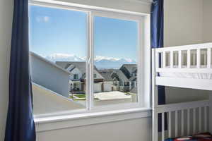 Bedroom with a mountain view and multiple windows