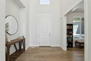 Entryway with a wealth of natural light, light wood-type flooring, and baseboards