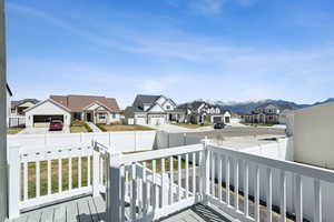 Wooden terrace featuring a residential view and fence private yard