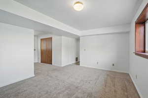 Empty room with baseboards and carpet