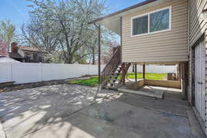View of patio featuring stairs, a fenced backyard, and central AC