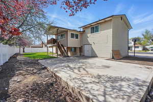Back of house featuring a lawn, a fenced backyard, a patio area, and stairs