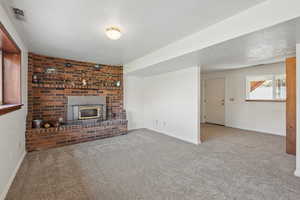 Unfurnished living room featuring carpet flooring and baseboards