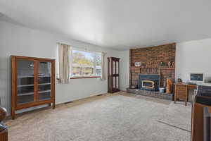 Carpeted living area featuring visible vents and baseboards