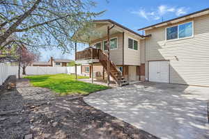 Back of house featuring a fenced backyard, a lawn, a patio area, brick siding, and stairs
