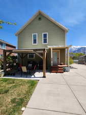 View of back of home with large Pergola perfect for outdoor gatherings or quiet time.