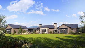 View of front of house featuring a chimney, a front lawn, and metal roof