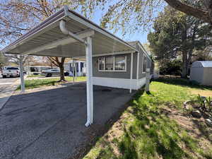 View of vehicle parking with a shed