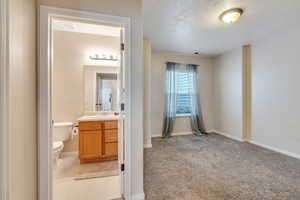 Half bathroom with visible vents, toilet, vanity, and baseboards