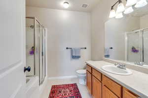 Full bath featuring visible vents, toilet, a shower stall, vanity, and tile patterned floors
