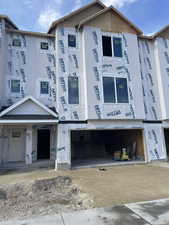 View of front of home featuring a garage and driveway