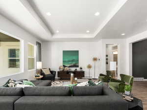 Living room featuring recessed lighting, visible vents, baseboards, and wood finished floors
