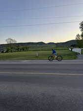 View of asphalt street featuring a mountain view