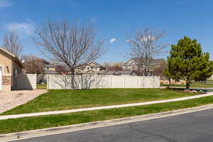 View of yard featuring fence and a residential view