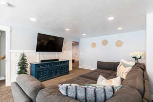 Living area featuring carpet floors, recessed lighting, and visible vents