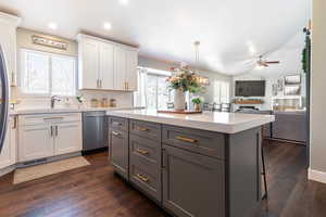 Kitchen with tasteful backsplash, a ceiling fan, white cabinets, visible vents, and dishwasher