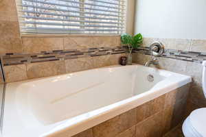 Full bath featuring a garden tub