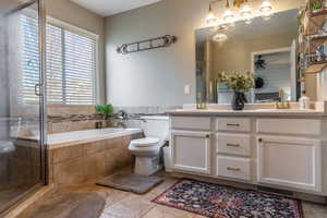Full bathroom with a sink, a bath, a ceiling fan, and double vanity