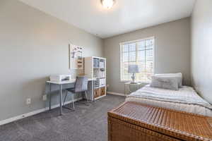 Carpeted bedroom featuring baseboards