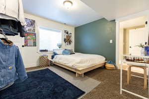 Carpeted bedroom with visible vents and baseboards