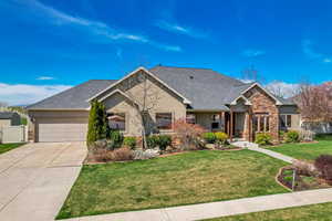 Ranch-style home featuring stucco siding, fence, a front lawn, a garage, and concrete driveway