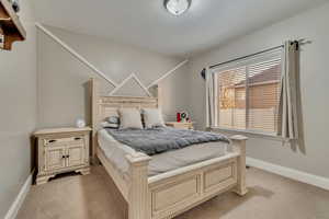 Bedroom featuring light colored carpet and baseboards