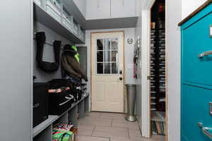 Mudroom with light tile patterned flooring