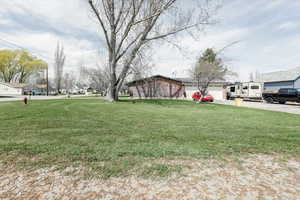 View of yard with an attached garage and driveway