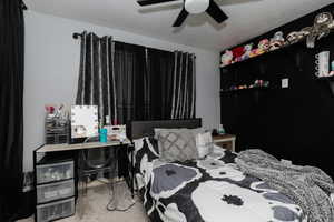 Bedroom with a ceiling fan and carpet floors