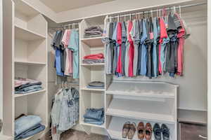 Spacious closet with carpet floors
