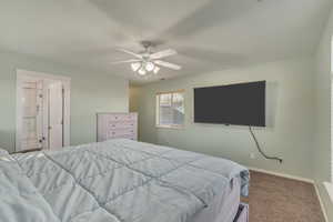 Bedroom with baseboards, a ceiling fan, and carpet flooring