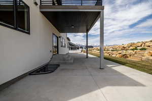 View of patio featuring a balcony and a mountain view