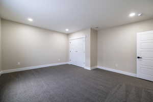 Unfurnished bedroom featuring dark carpet, a closet, visible vents, recessed lighting, and baseboards
