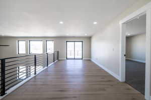 Unfurnished room with baseboards, recessed lighting, and wood finished floors