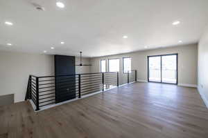 Empty room featuring ceiling fan, recessed lighting, wood finished floors, and baseboards