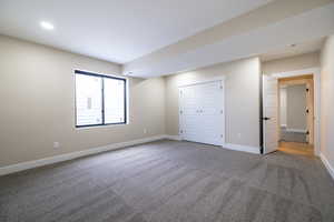 Unfurnished bedroom with a closet, baseboards, and carpet