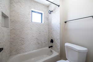 Bathroom with toilet and bathtub / shower combination