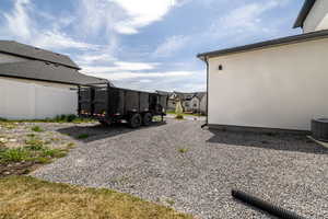 View of yard with cooling unit and fence