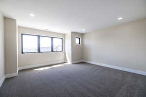 Unfurnished room featuring visible vents, baseboards, recessed lighting, and carpet flooring