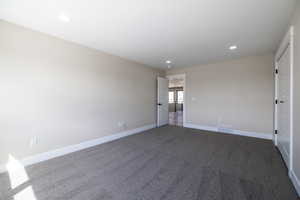 Unfurnished room with recessed lighting, visible vents, baseboards, and carpet floors
