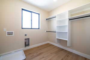 Laundry room with electric dryer hookup, baseboards, washer hookup, laundry area, and light wood finished floors
