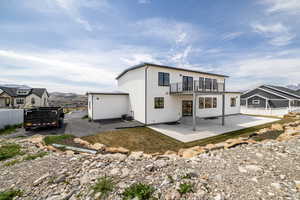 Back of property with a patio area, a fenced backyard, central AC unit, and a balcony