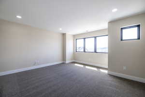 Unfurnished room with visible vents, baseboards, recessed lighting, and carpet flooring