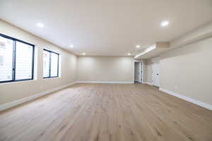 Interior space featuring baseboards, recessed lighting, and light wood-style floors