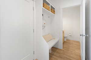 Mudroom with baseboards and light wood finished floors