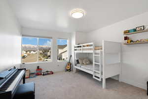 Carpeted bedroom with baseboards and a residential view