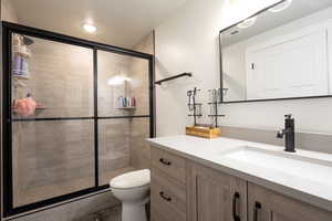 ADU Bathroom featuring vanity, a stall shower, and toilet