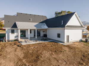 Back of house with a patio area