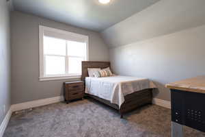 Bedroom with  baseboards, vaulted ceiling, and carpet floors